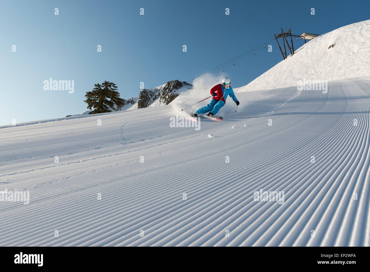 Squaw Valley skier with beautiful groomed snow beneath the palisades on Siberia Lift at Squaw Valley Ski Resort, CA Stock Photo