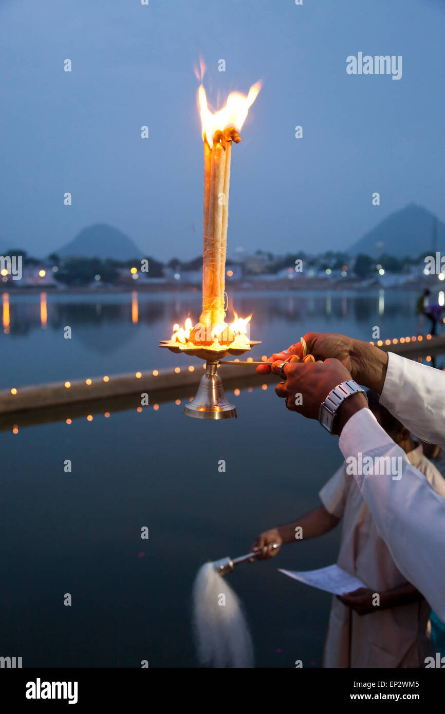 India, Rajasthan, Brahmin with oil lamp during a religious ceremony at Pushkar Lake Stock Photo