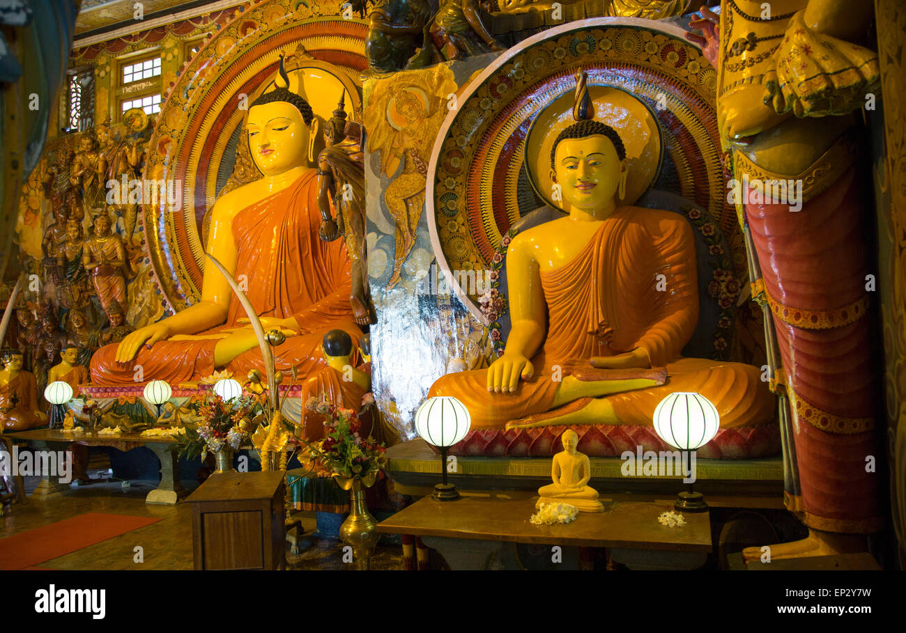 Large Buddha statues at Gangaramaya Temple, Colombo, Sri Lanka, Stock Photo