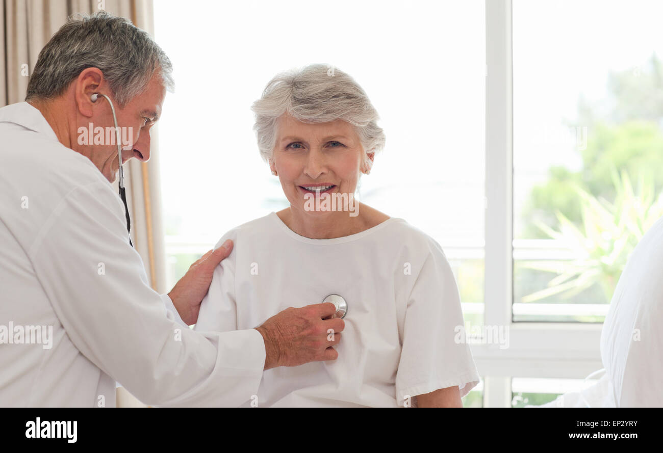 Senior doctor taking the heartbeat of his patient Stock Photo - Alamy