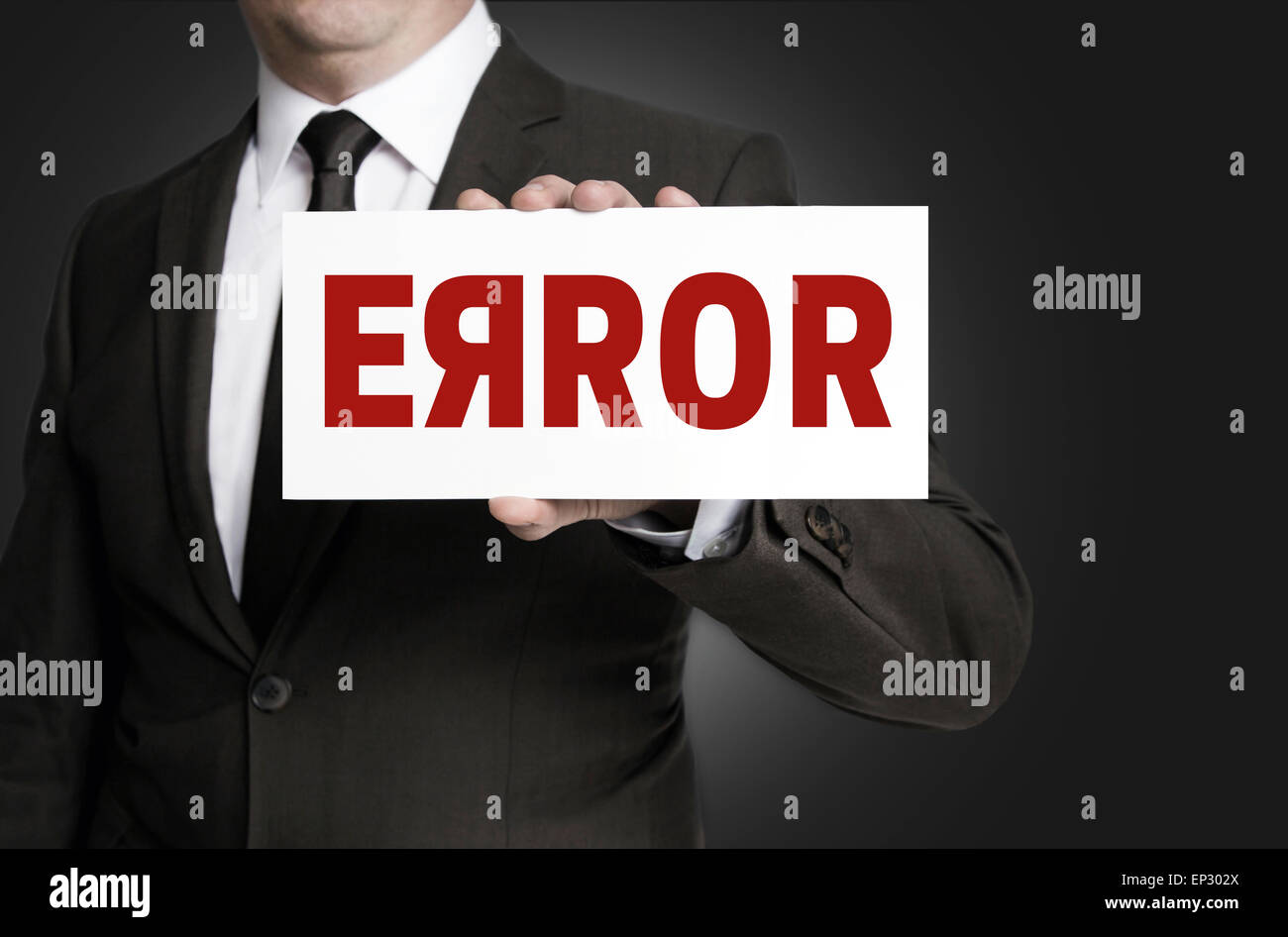 Error sign held by businessman. Stock Photo