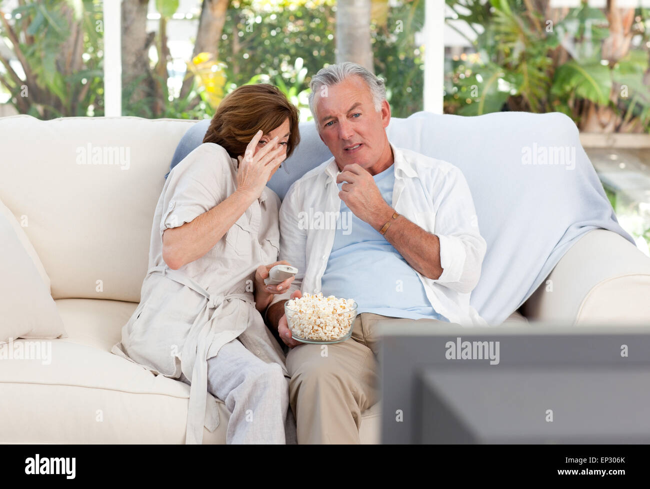 Seniors watching tv at home Stock Photo Alamy