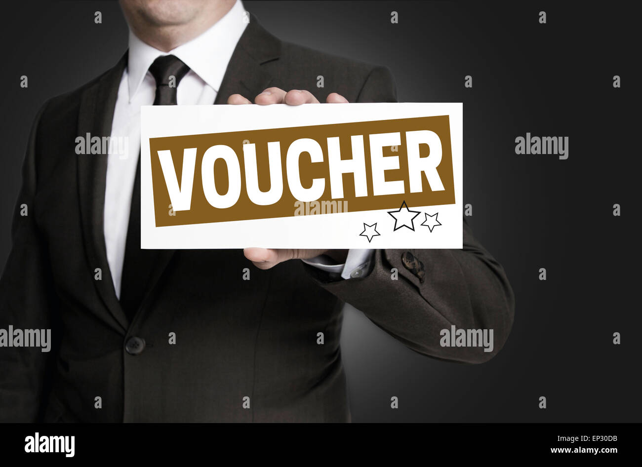 Voucher sign is held by businessman. Stock Photo