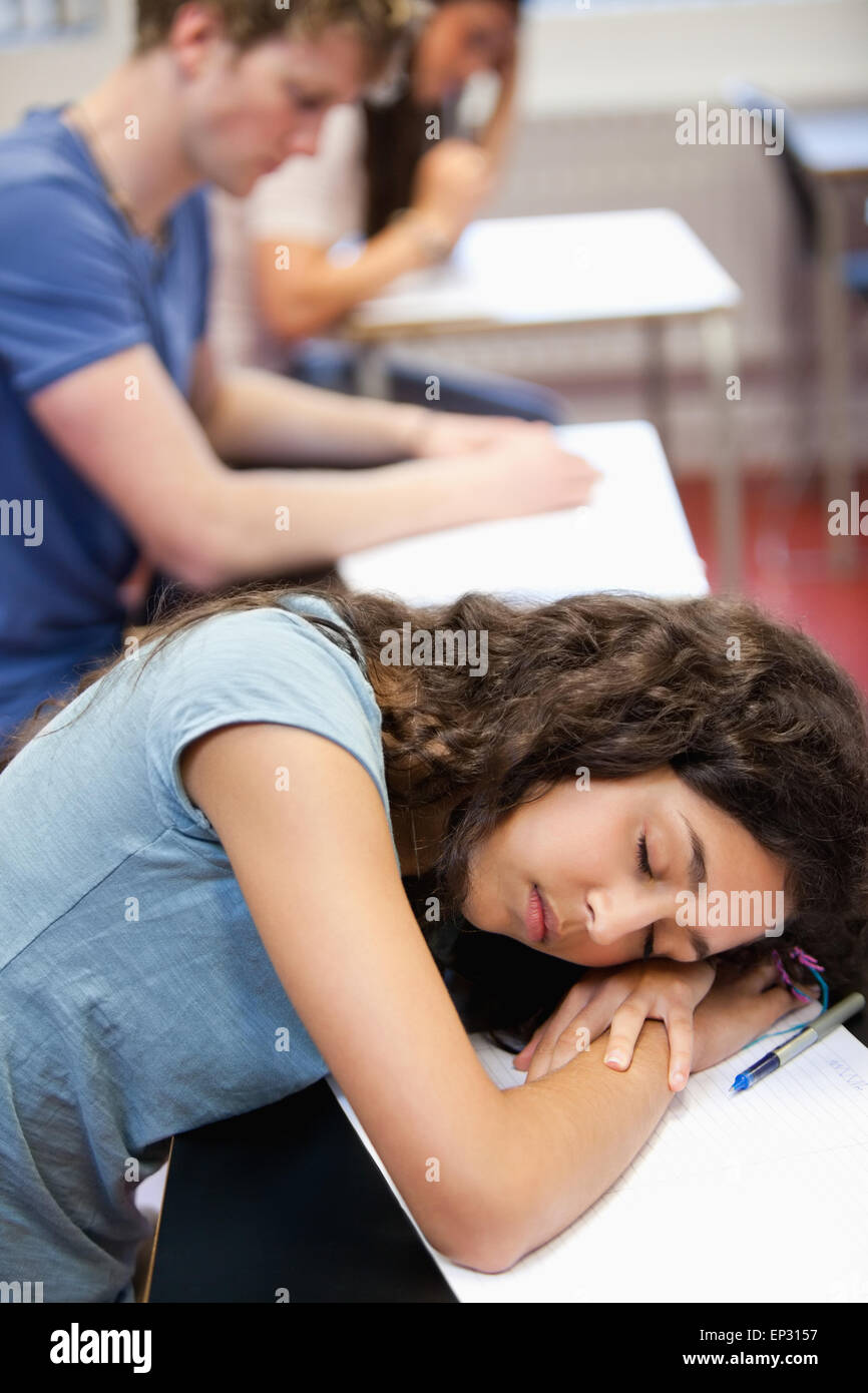 Portrait of a student sleeping on her desk Stock Photo