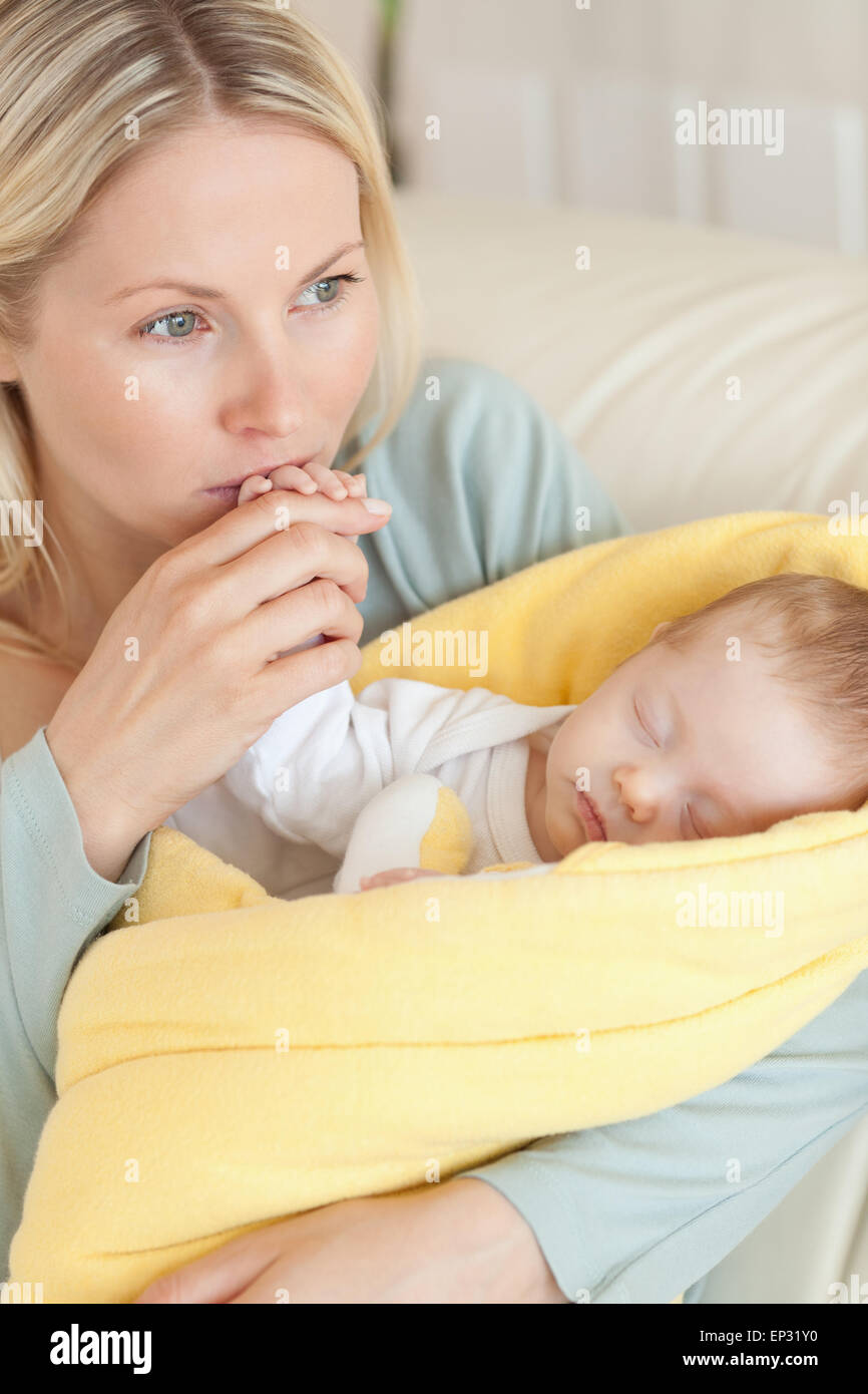 Close up of provident mother kissing her baby's hand Stock Photo Alamy