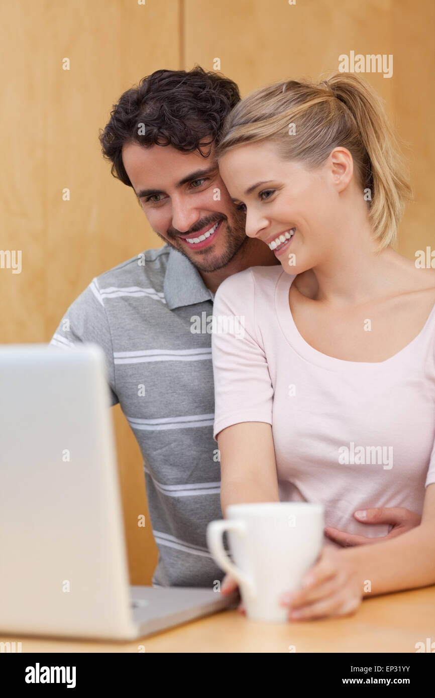 Portrait of a couple using a laptop while having tea Stock Photo