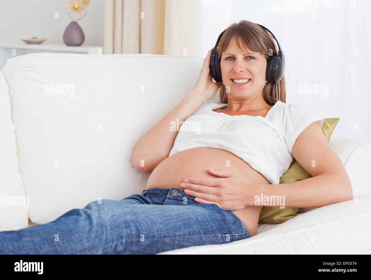 Close up of a pregnant woman listening to music Stock Photo - Alamy