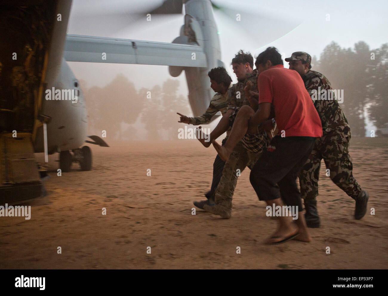 Kathmandu, Nepal. 13th May, 2015. A U.S. Air Force pararescueman with Joint Task Force 505 helps evacuate earthquake victims onto a U.S. Marine Corps MV-22 Osprey May 12, 2015 in Chericot, Nepal. A 7.3 magnitude aftershock earthquake struck the kingdom following the 7.8 magnitude earthquake on April 25th. Stock Photo