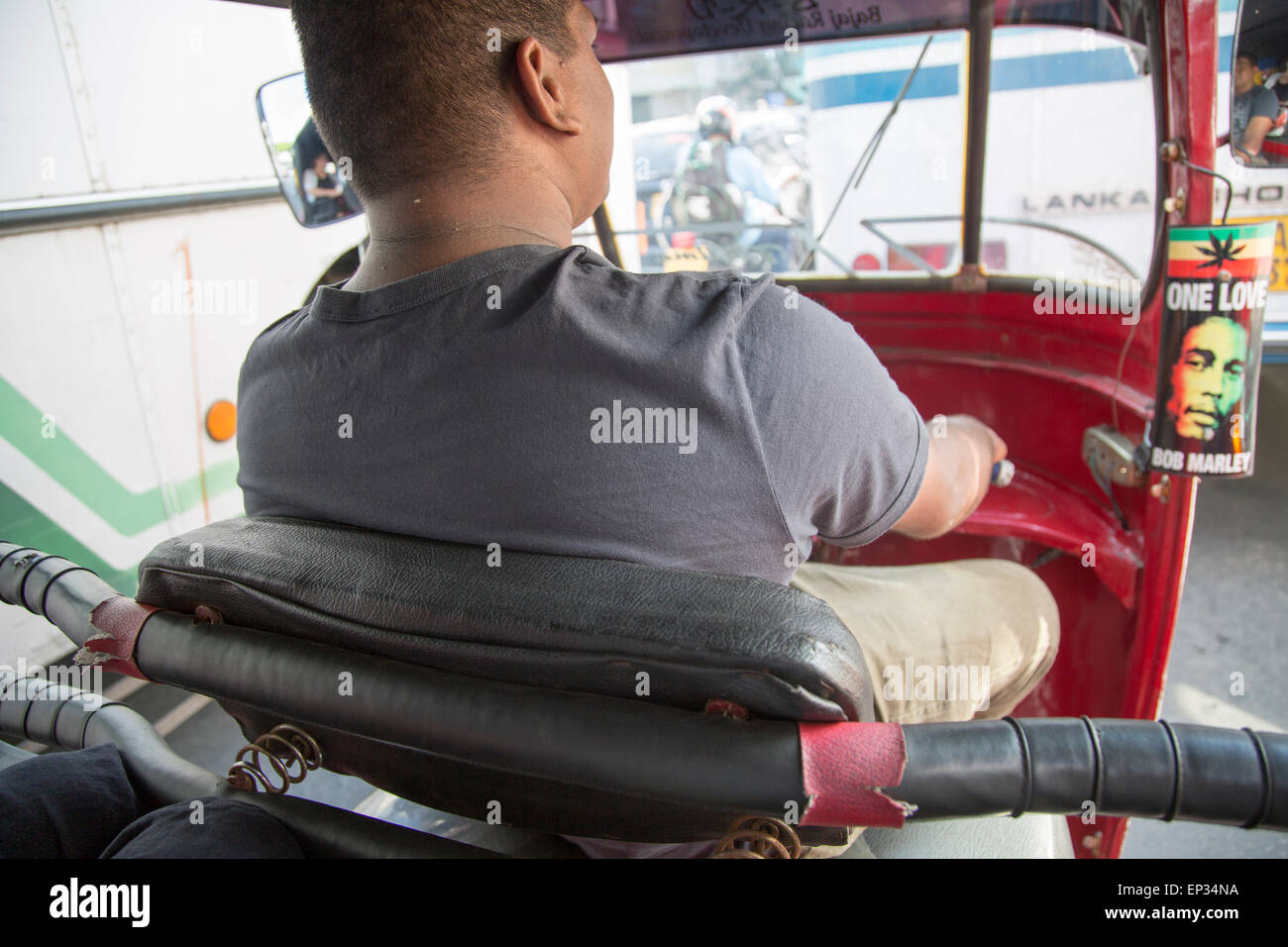 Motorised rickshaw Tuk Tuk driver in traffic of central city area of Colombo, Sri Lanka, Asia Stock Photo