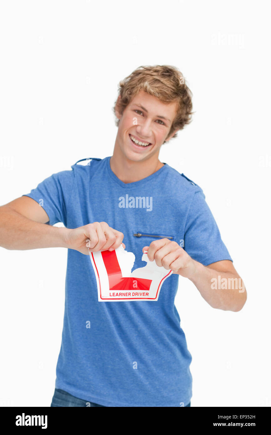 Happy young man ripping a learner driver sign Stock Photo - Alamy