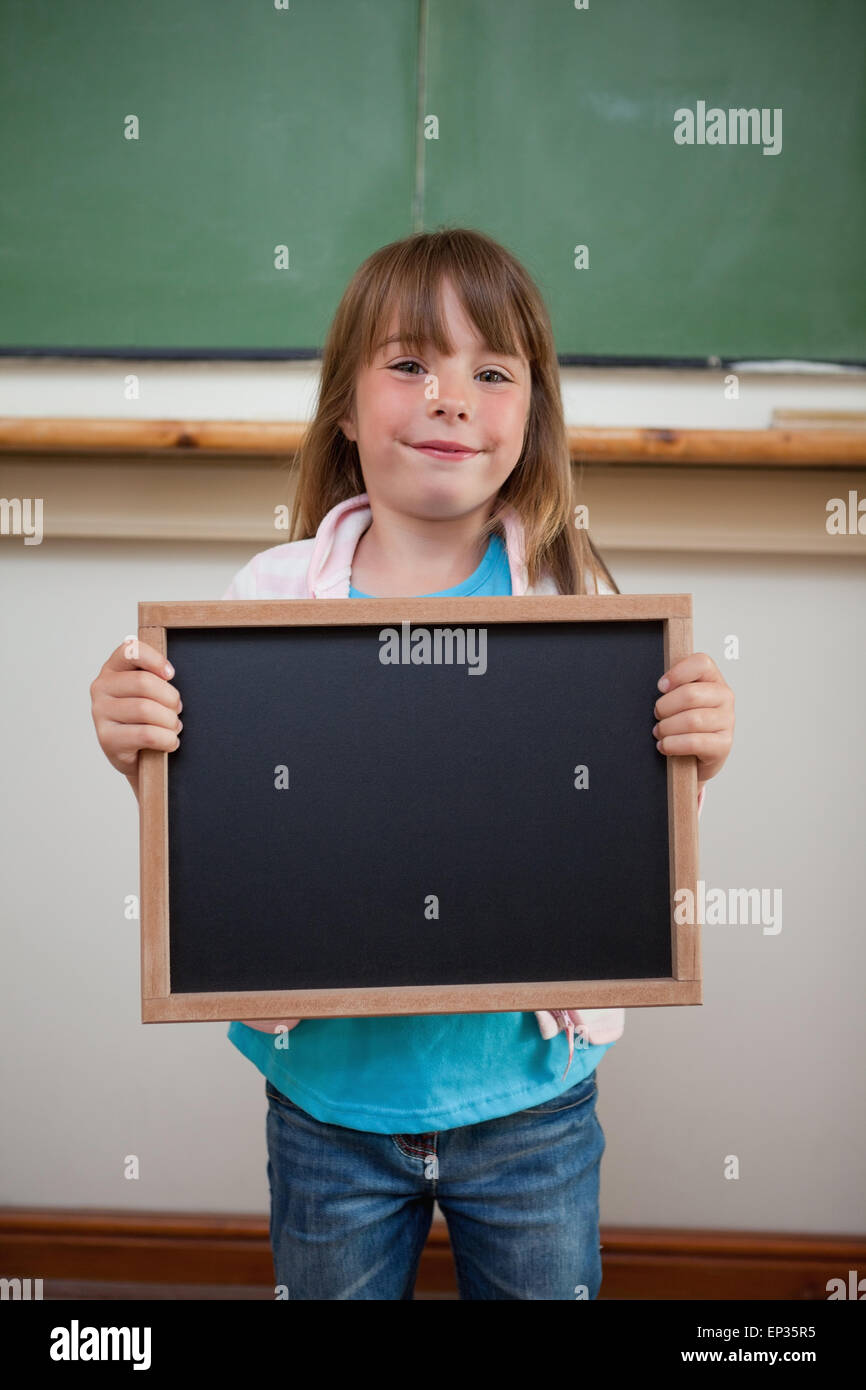 Portrait of a smiling girl holding a school slate Stock Photo - Alamy