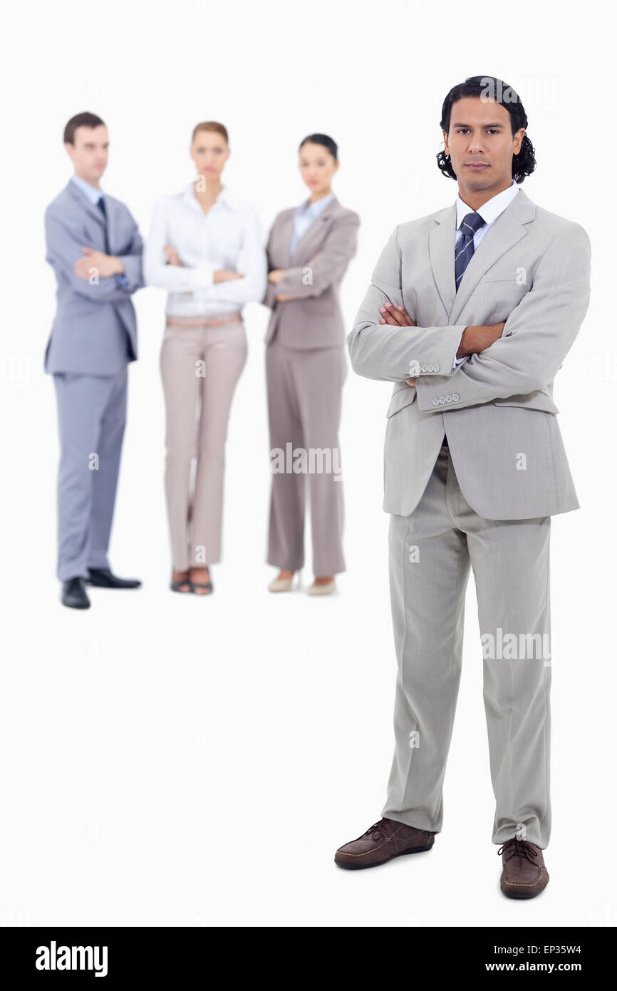 Businessman crossing his arms with serious people in background Stock ...