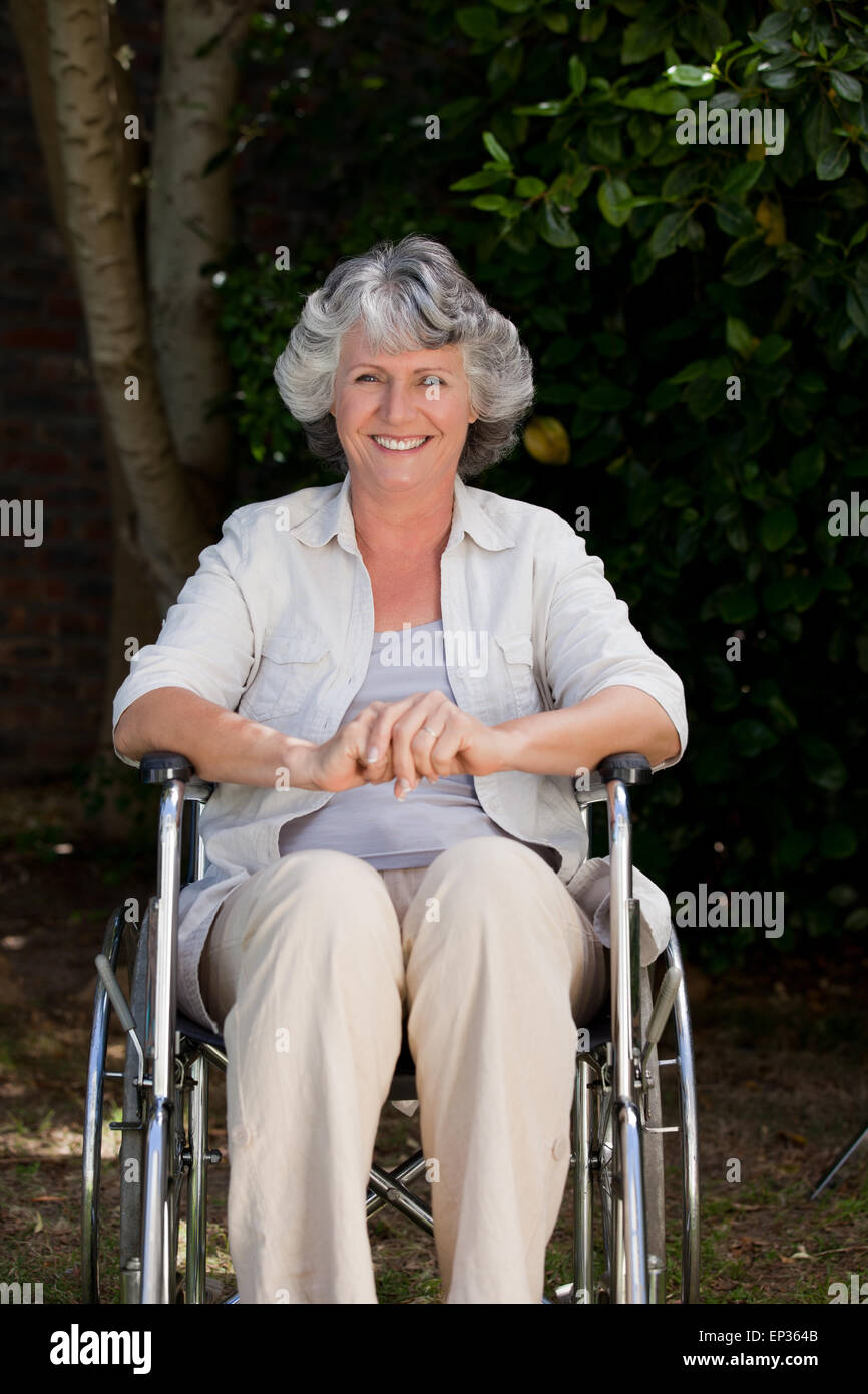 Smiling woman in her wheelchair Stock Photo - Alamy