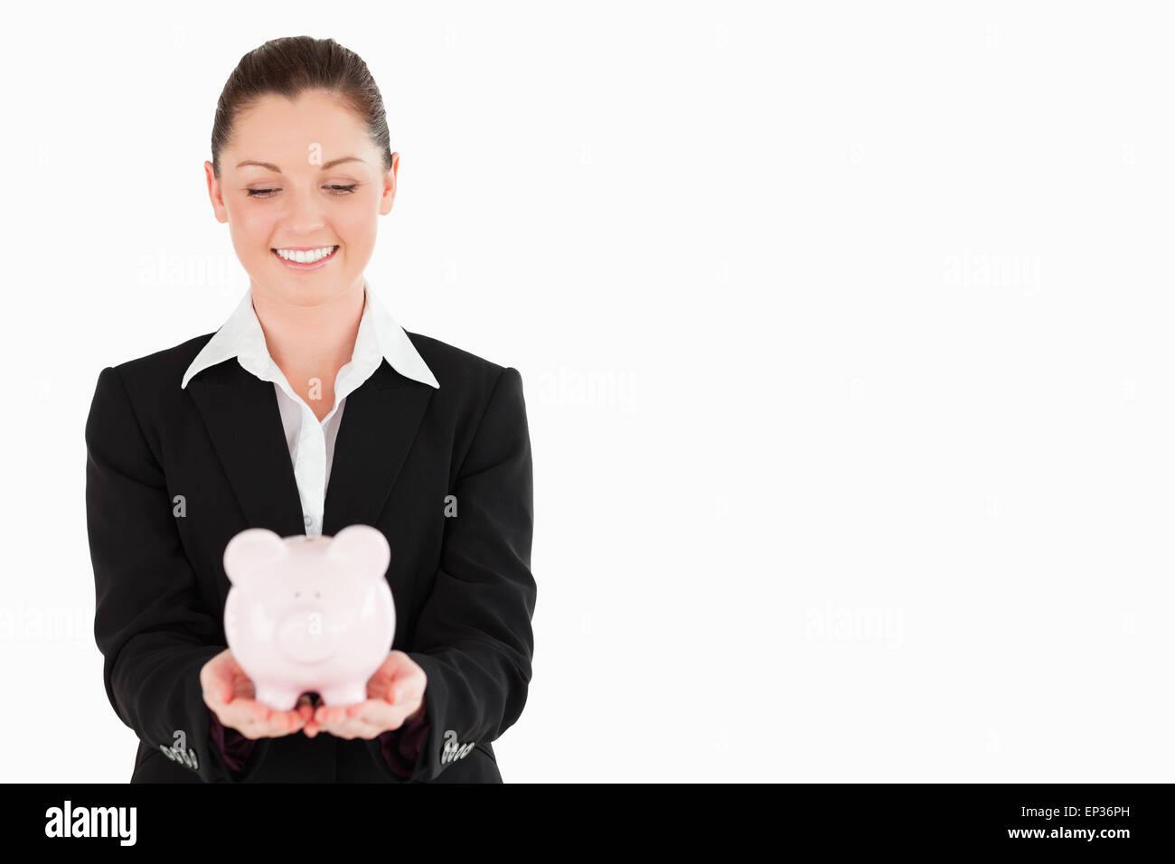 Gorgeous woman in suit holding a pink piggy bank Stock Photo - Alamy