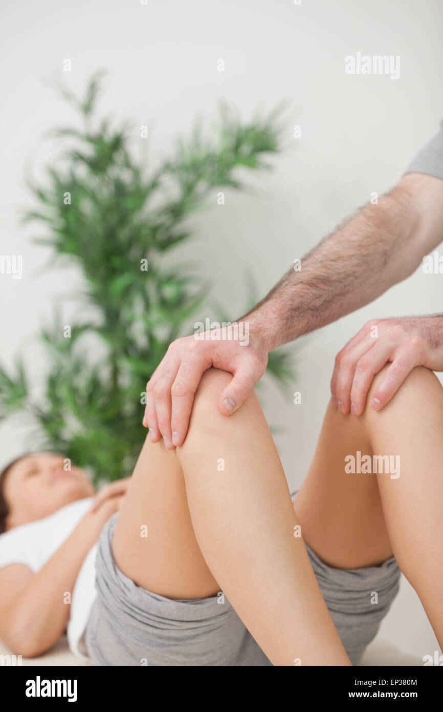 Peaceful woman lying on a medical table with her knees bent Stock Photo