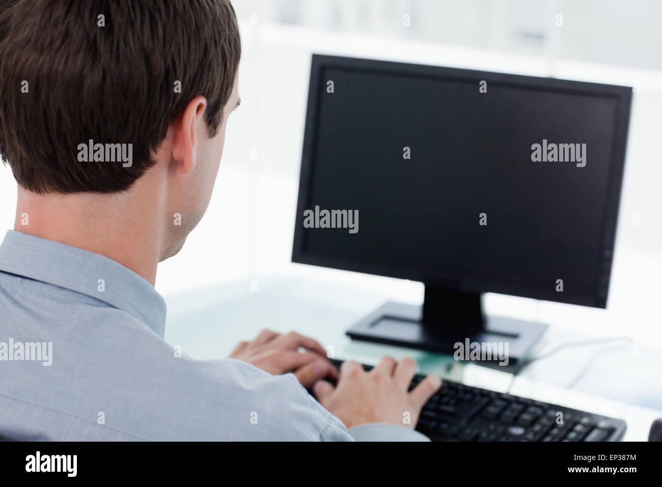 Back view of a businessman working with a computer Stock Photo