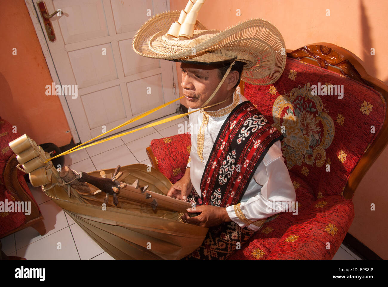 Man wearing traditional clothes as he plays sasando music instrument of Rote Island, Indonesia. Stock Photo