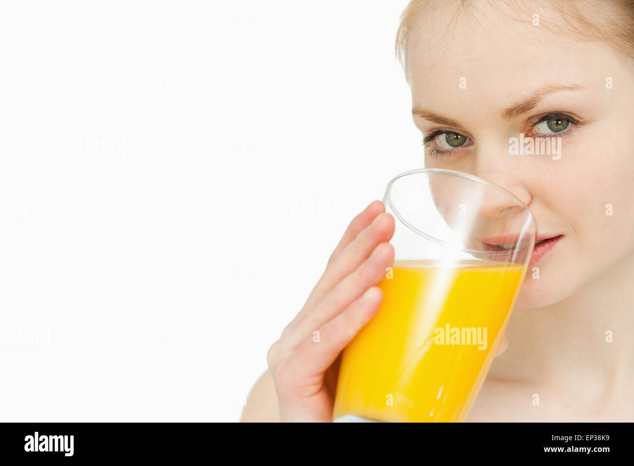 Young woman drinking a glass of orange juice Stock Photo