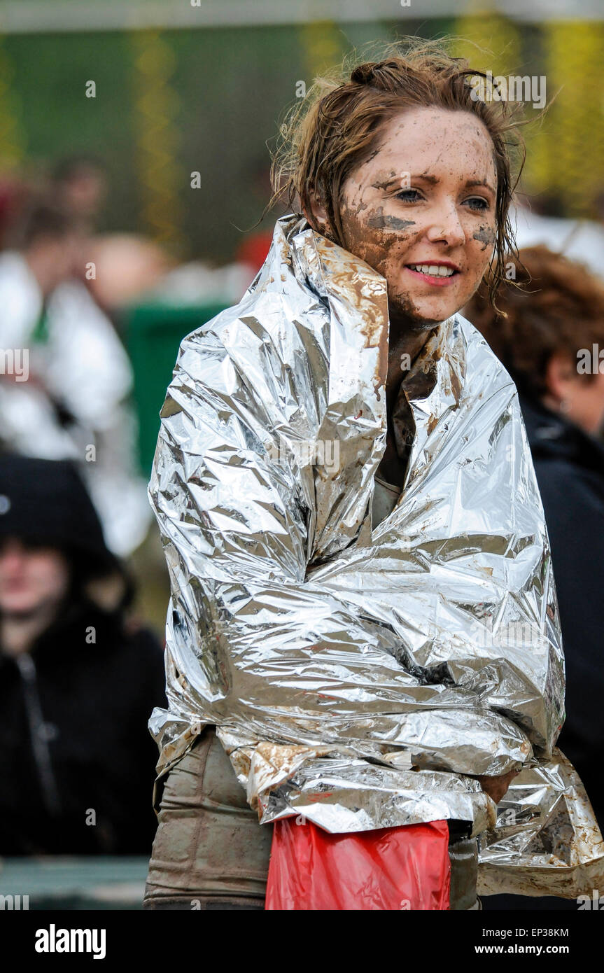 Young woman wrapped in emergency rescue blanket after completing ...
