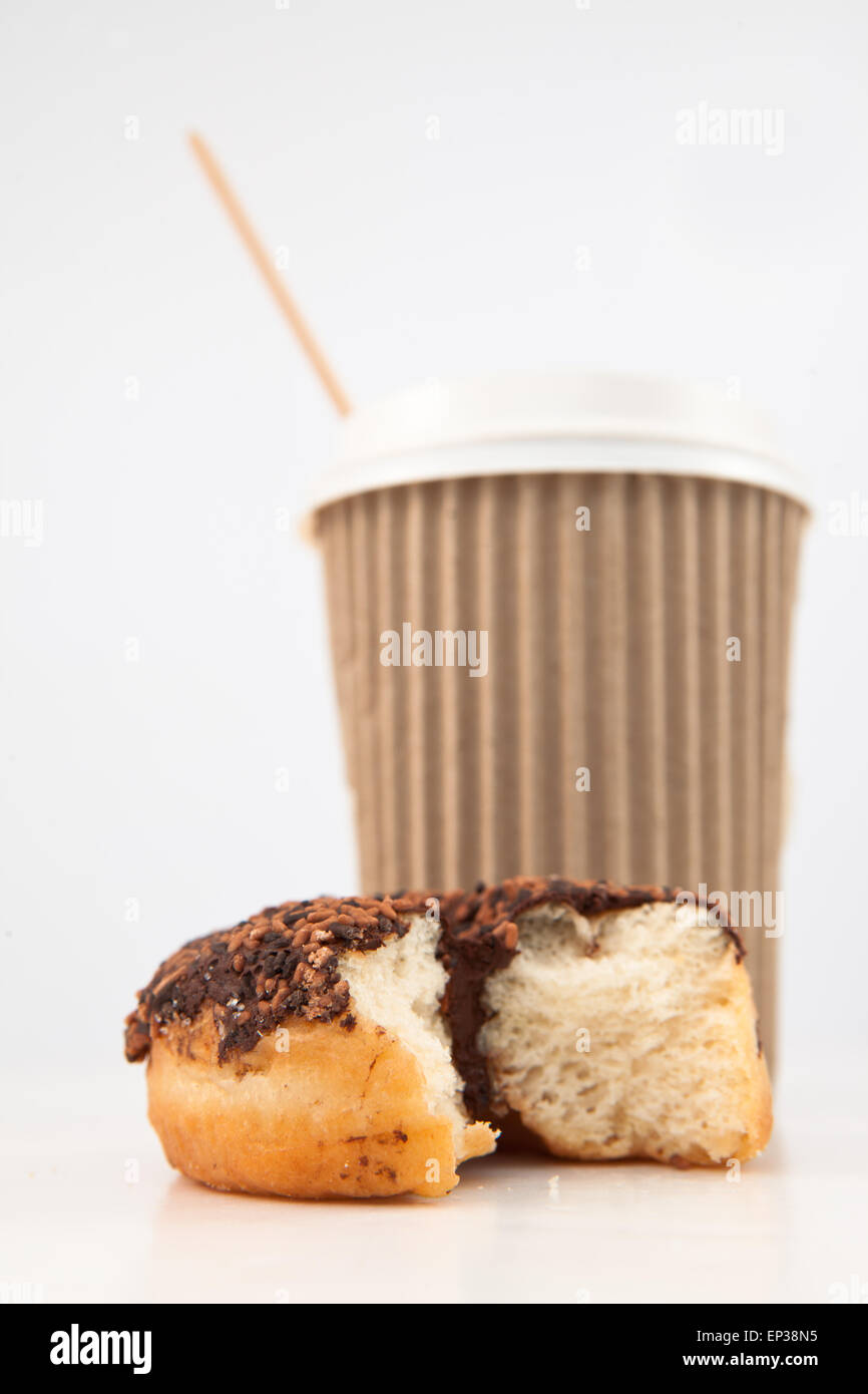 An half eaten doughnut and a cup of coffee placed together Stock Photo