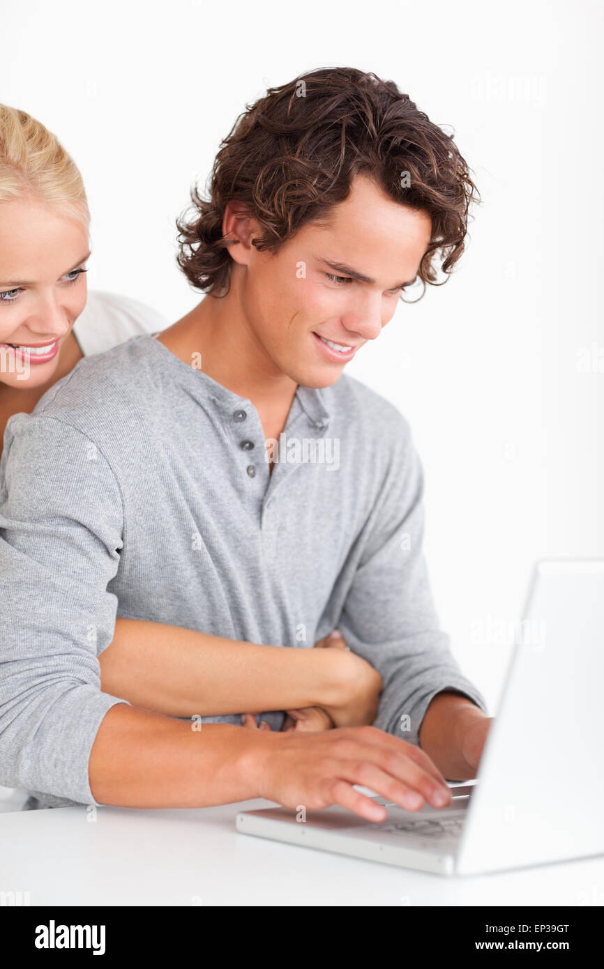 Portrait of a cute couple using a laptop Stock Photo - Alamy