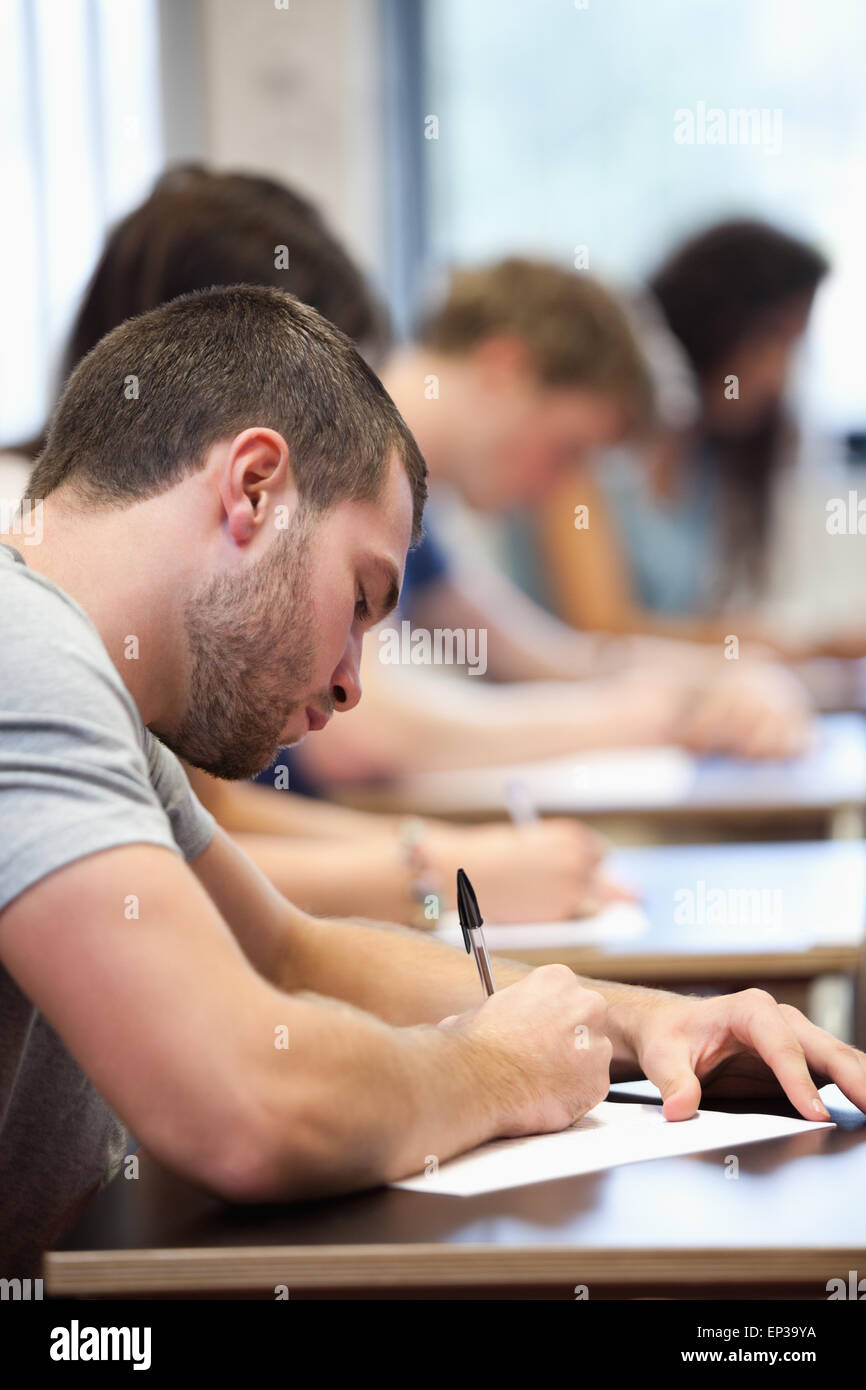 Portrait of a young man writing Stock Photo - Alamy