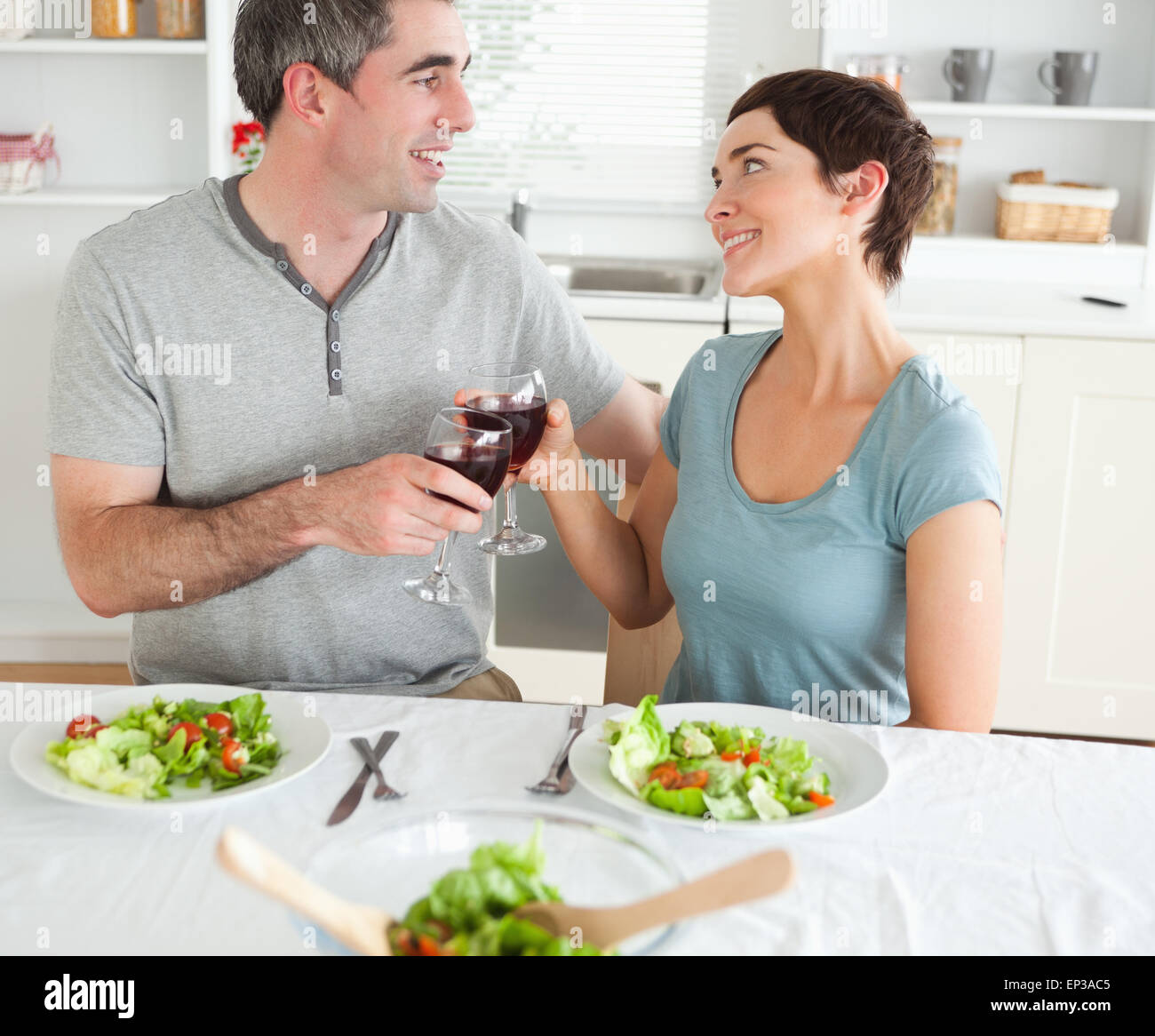 Close up of a cute couple toasting with redwine Stock Photo