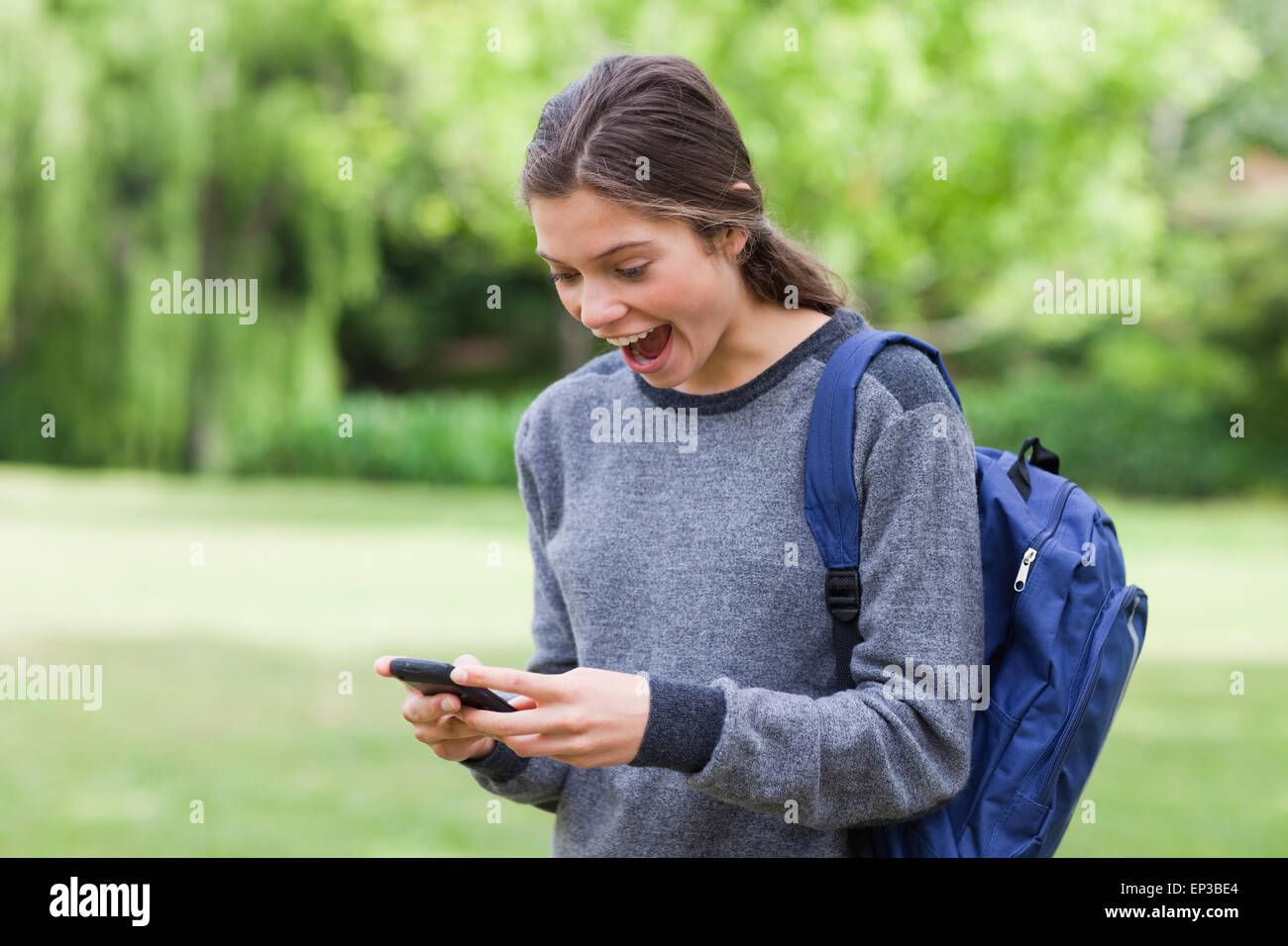 Young girl showing her surprise after receiving a text Stock Photo - Alamy