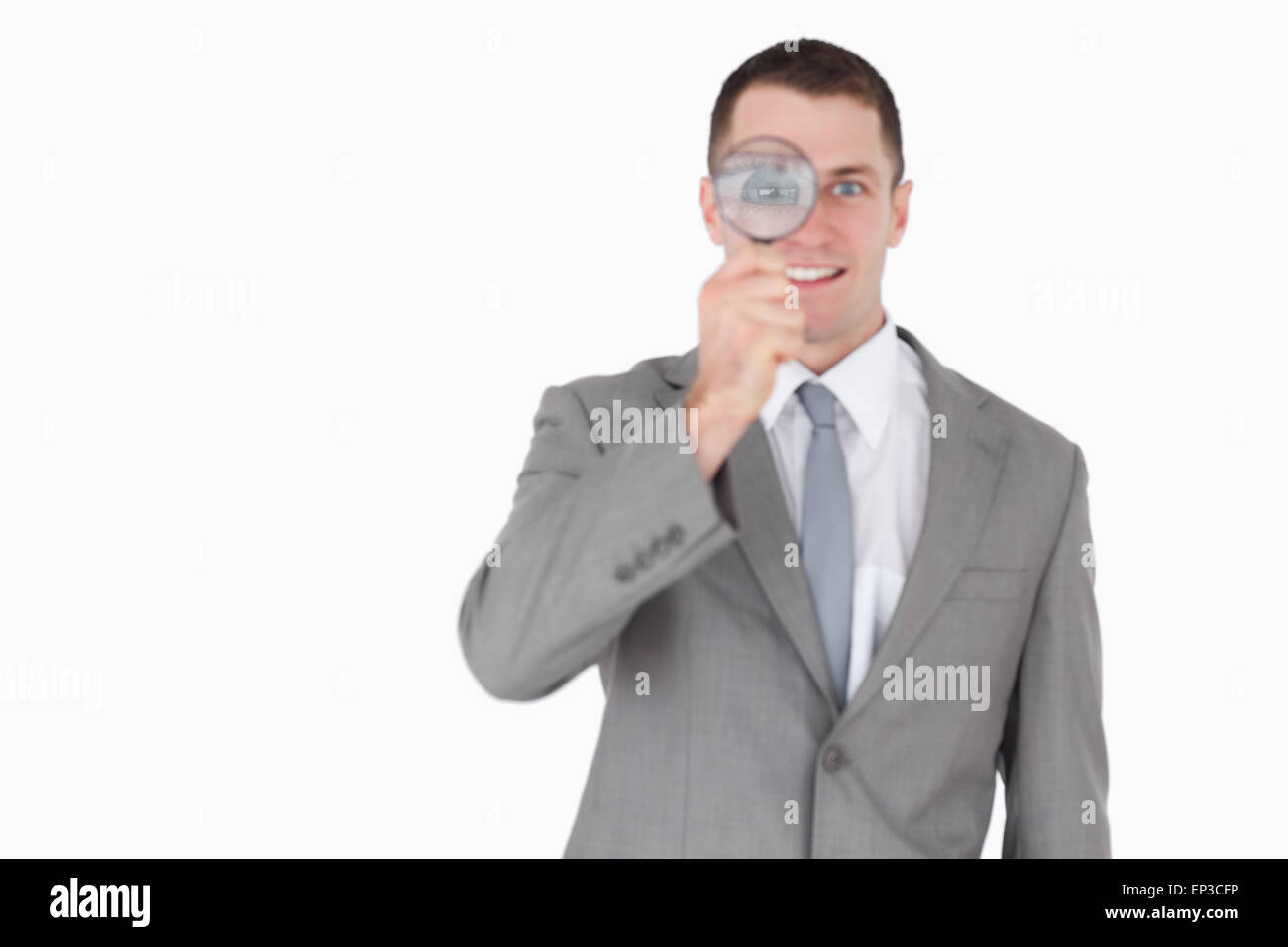 Businessman looking through a magnifying glass Stock Photo - Alamy