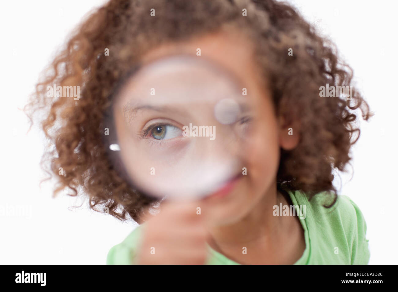 Smiling girl looking through a magnifying glass Stock Photo - Alamy