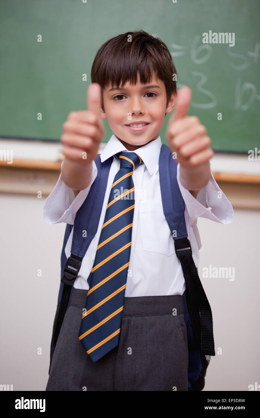 Portrait of a smiling schoolboy with the thumbs up Stock Photo - Alamy