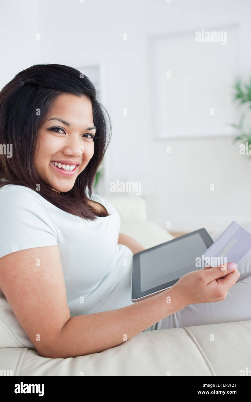 Woman smiling while holding a card and a tactile tablet Stock Photo - Alamy