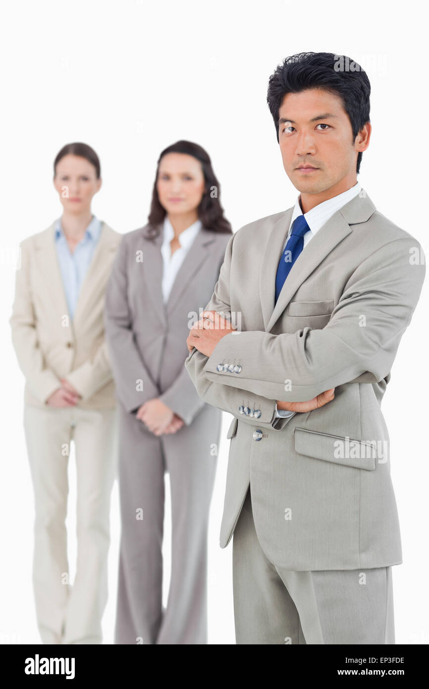 Confident looking businessman with his team behind him Stock Photo - Alamy