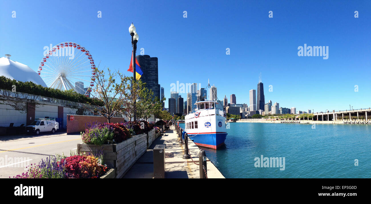 Chicago, Illinois, United States of America: a tourist boat in the canal of the Michigan Lake with view of the Navy pier Ferris Wheel Stock Photo