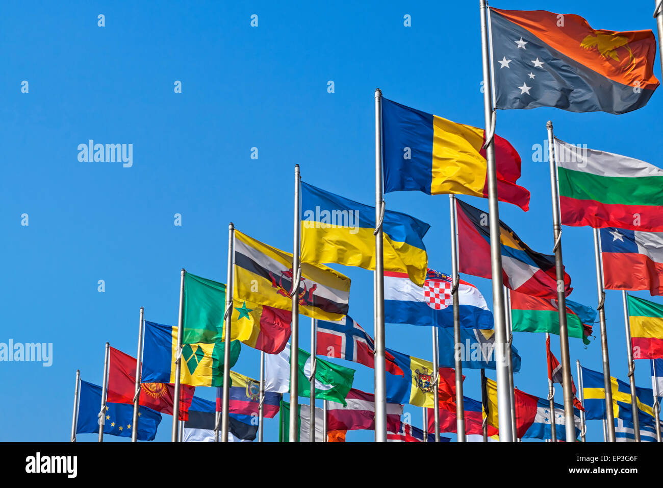 Different countries flags united together against blue sky Stock Photo