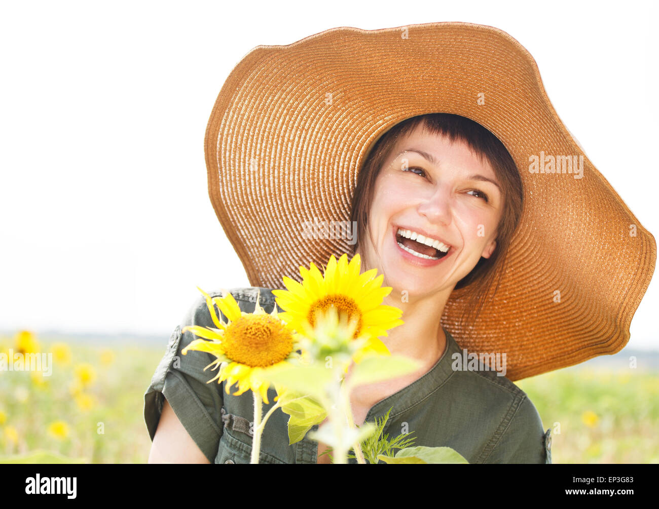 Portrait of a young smiling woman with sunflower Stock Photo - Alamy