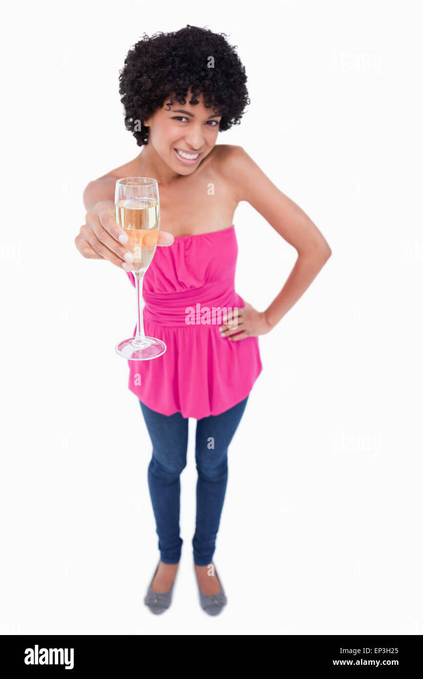 Young woman smiling while holding a glass of white wine Stock Photo - Alamy