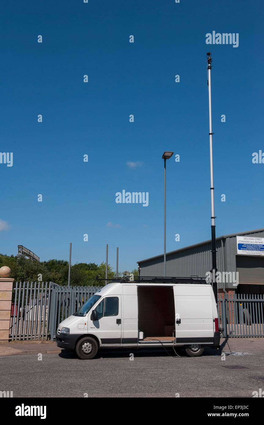 Transit van with a camera mounted on a telescopic pole to enable elevated photography. Stock Photo
