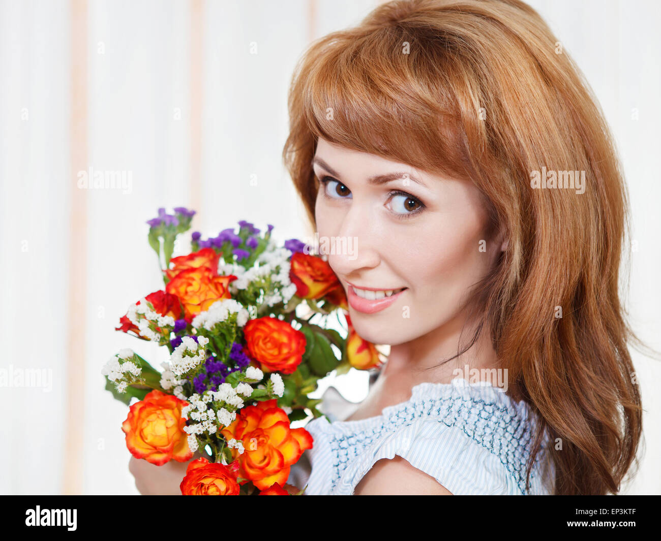 Happy young woman holding bid bouquet of flowers Stock Photo - Alamy