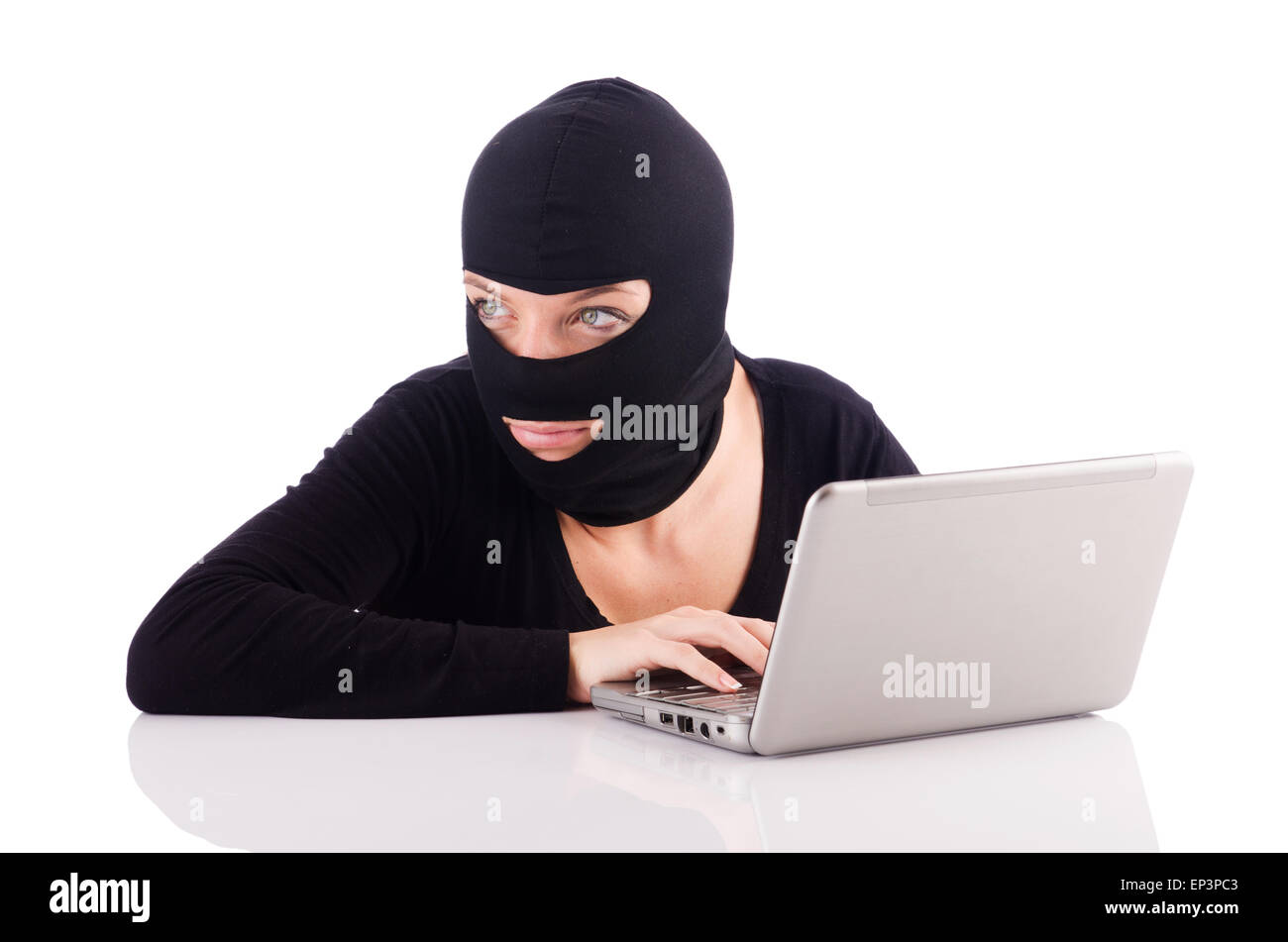 Hacker with computer wearing balaclava Stock Photo - Alamy
