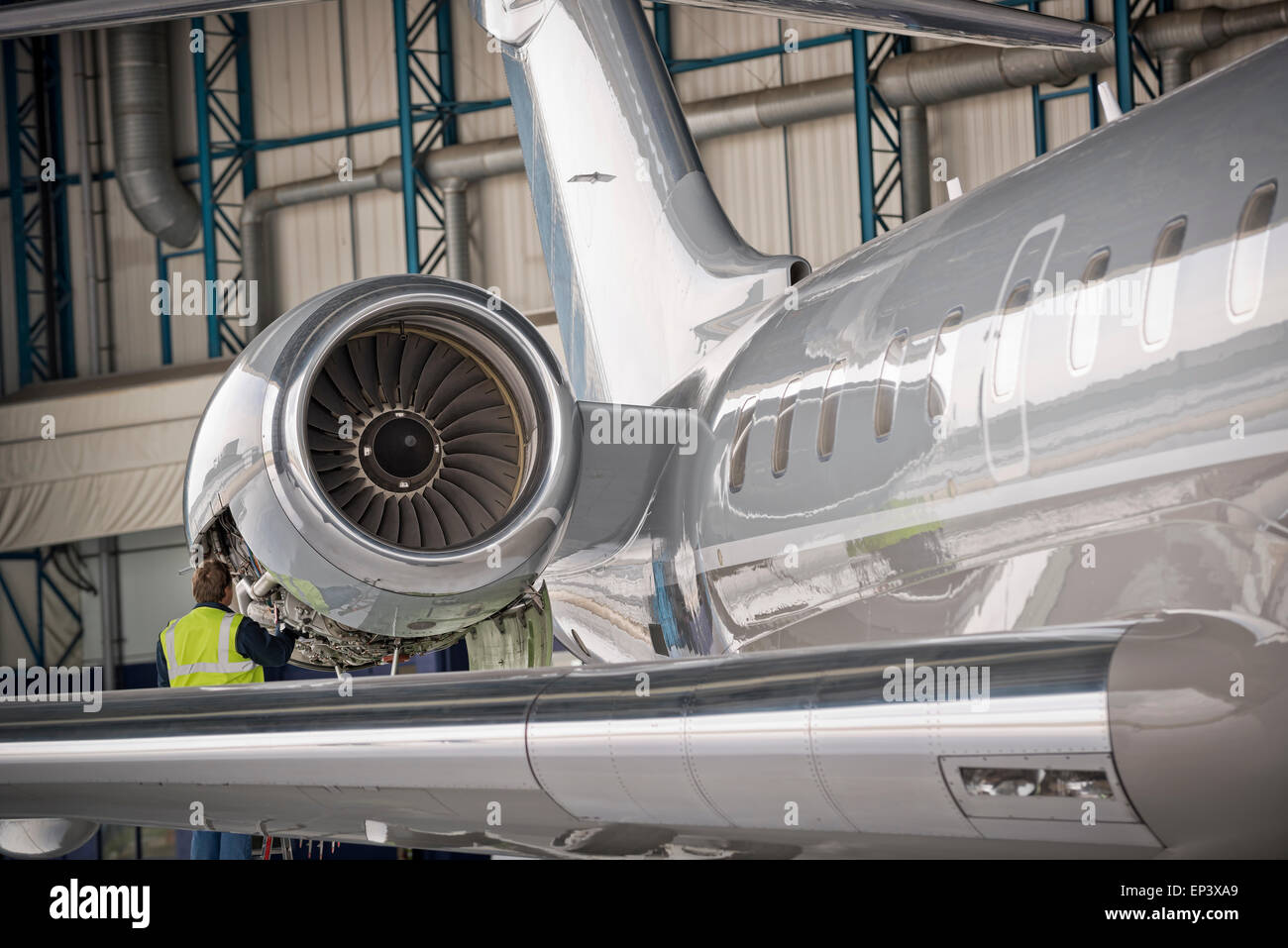 Aircraft mechanic inspecting airplane's jet engine Stock Photo