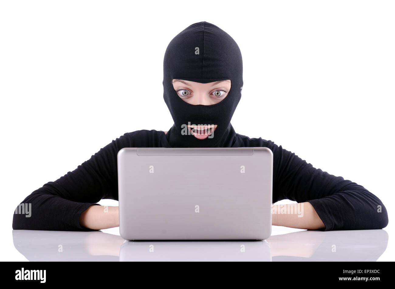 Hacker with computer wearing balaclava Stock Photo - Alamy
