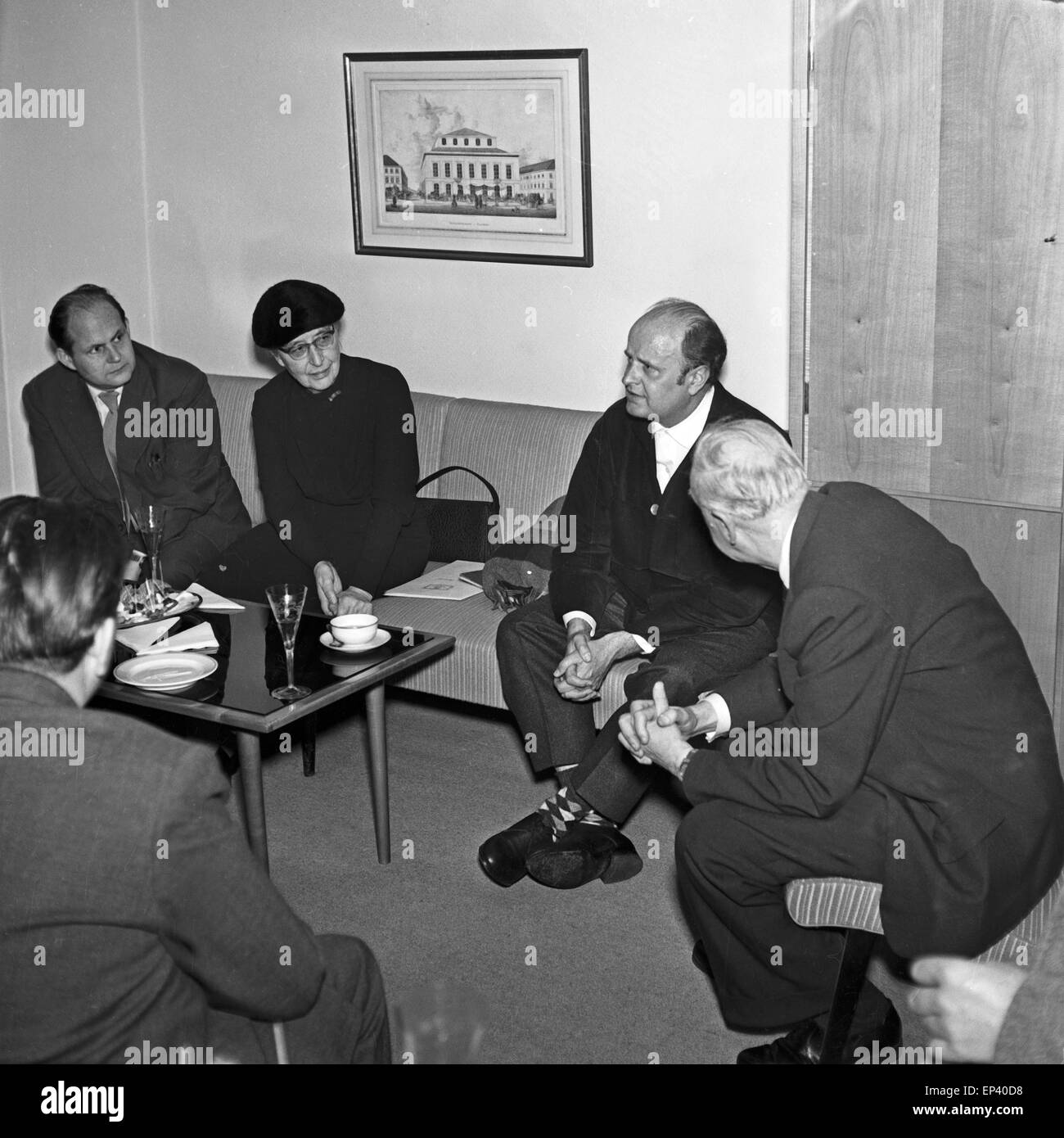Männer sitzen mit einer älteren Dame in einem Besprechungsraum bei einem Glas Sekt in Hamburg, Deutschland 1950er Jahre. Men sit Stock Photo