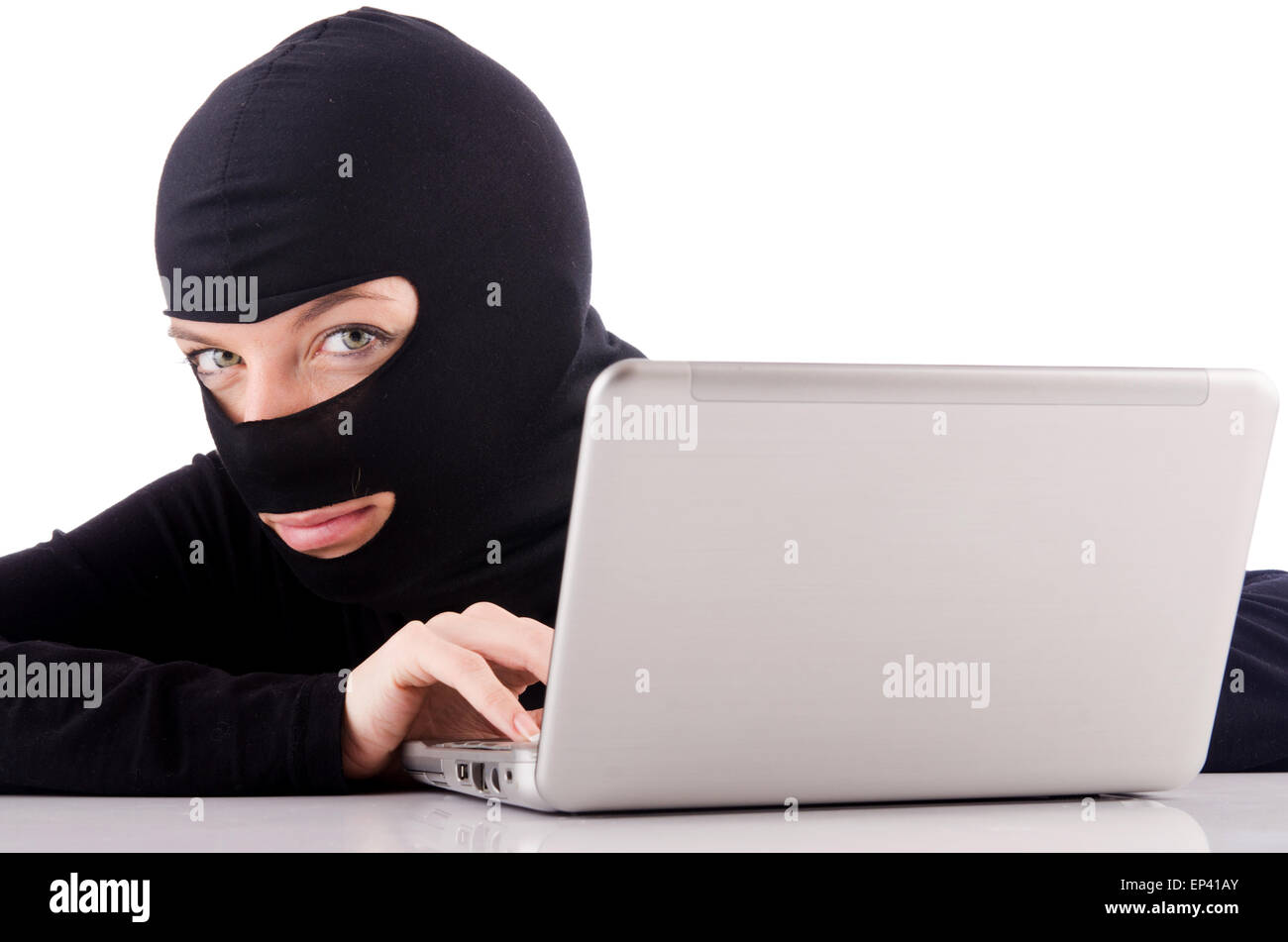 Hacker with computer wearing balaclava Stock Photo - Alamy
