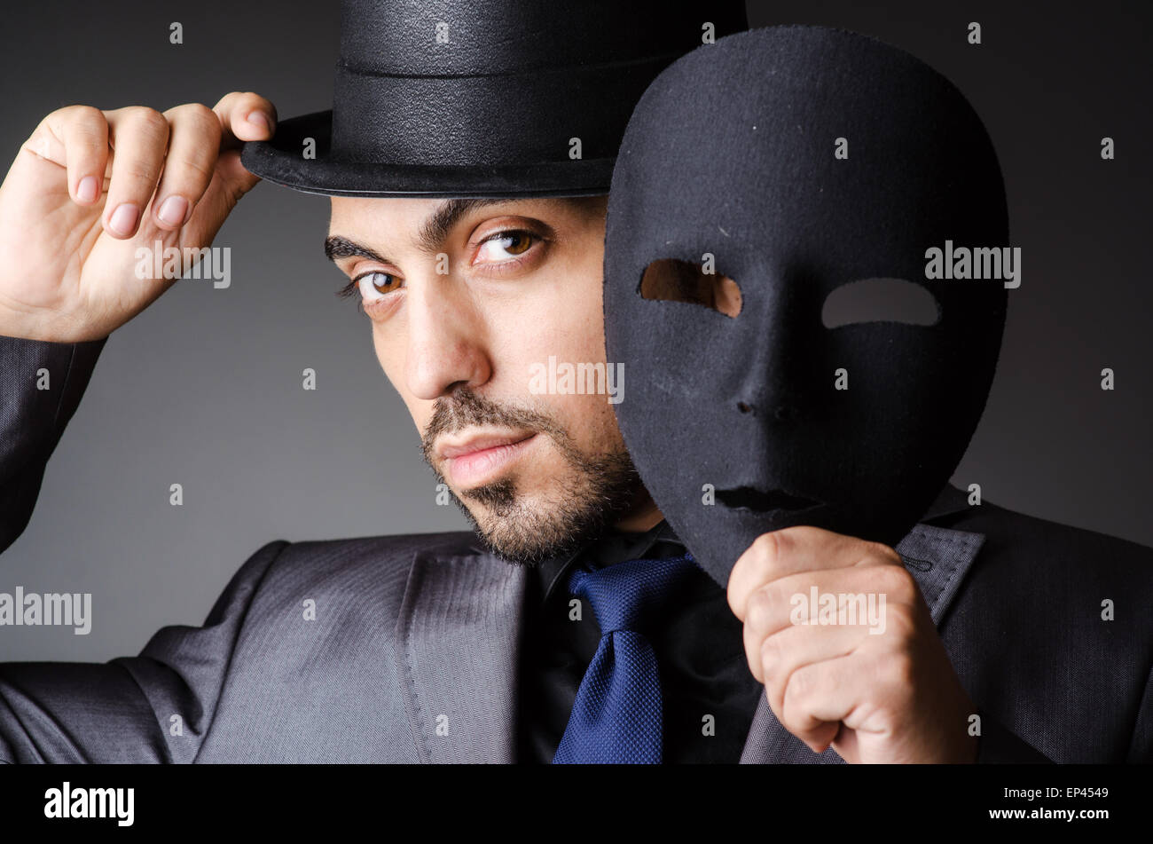 Man with mask in the dark Stock Photo - Alamy