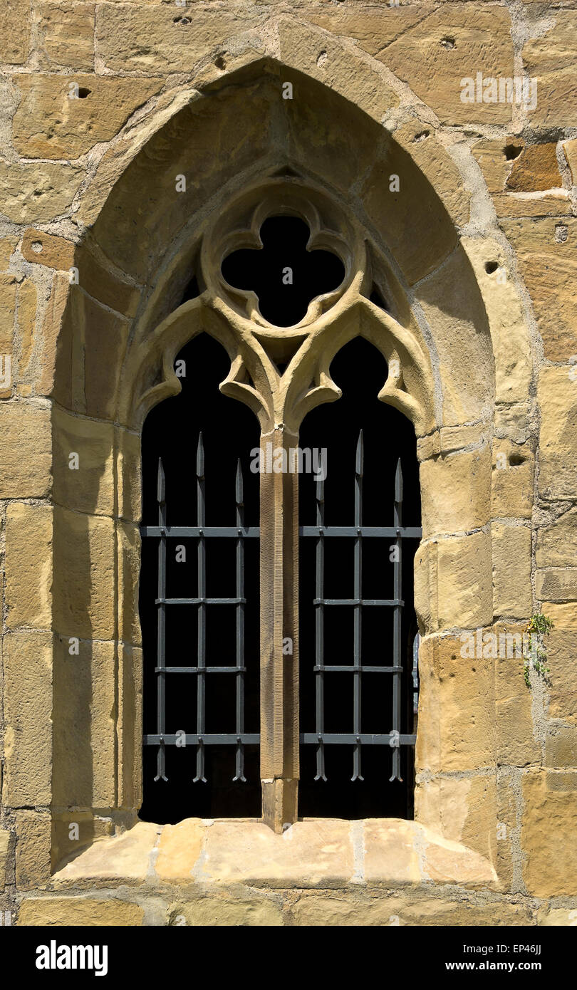Gothic window with tracery in a wall opening. Stock Photo