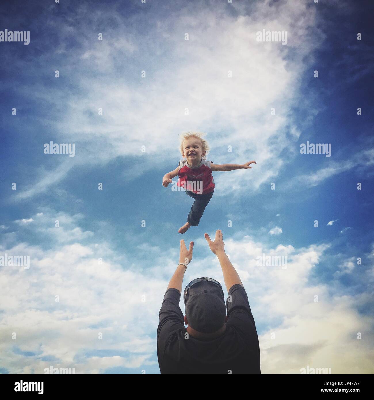 Father throwing his son in the air Stock Photo
