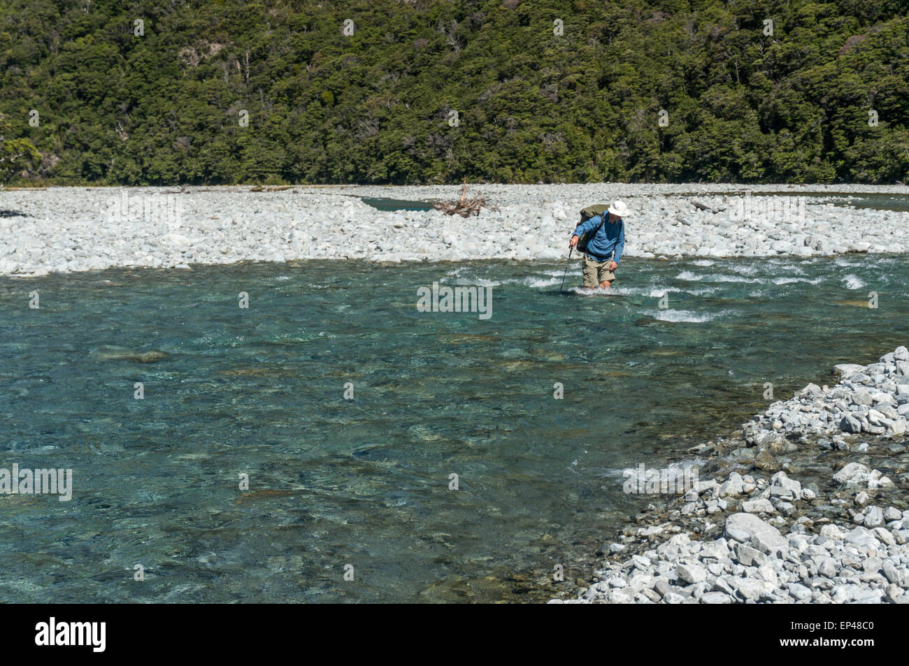 Man crossing a river, Arthur's Pass National Park, NZ Stock Photo