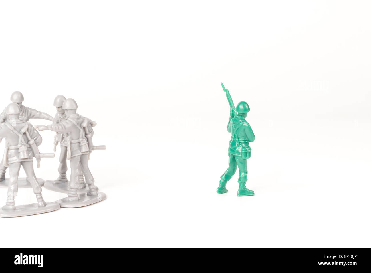 Gray toy soldiers excluding the green toy soldier Stock Photo
