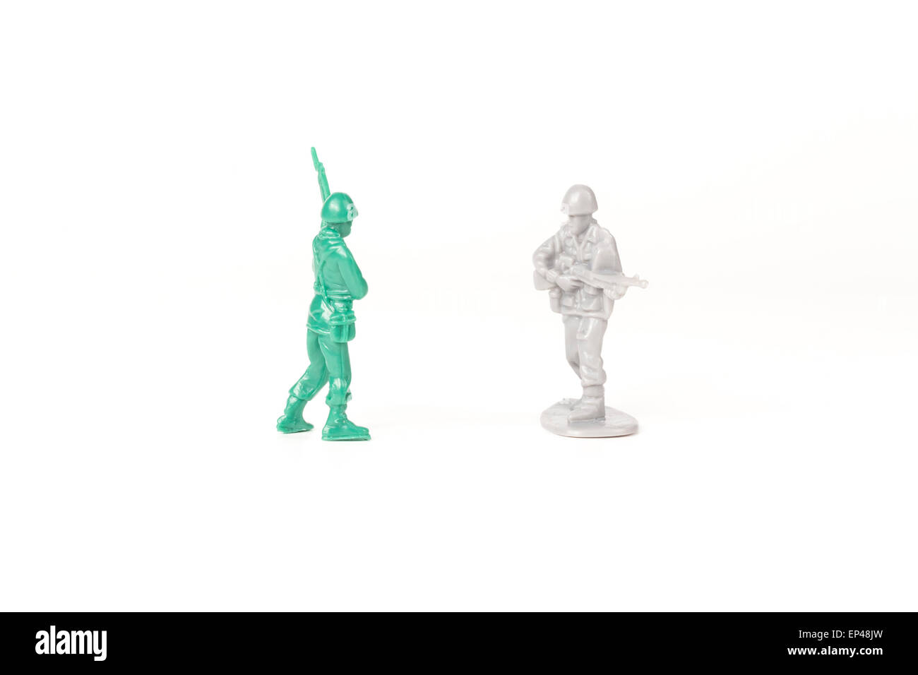 Two different toy army men cross paths Stock Photo